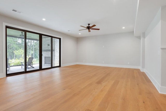 spare room with ceiling fan and light wood-type flooring