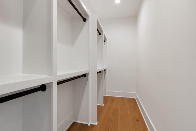 walk in closet featuring light hardwood / wood-style flooring