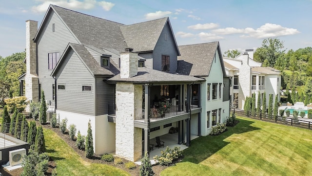 rear view of property with a lawn