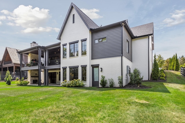 back of property featuring a yard and a balcony