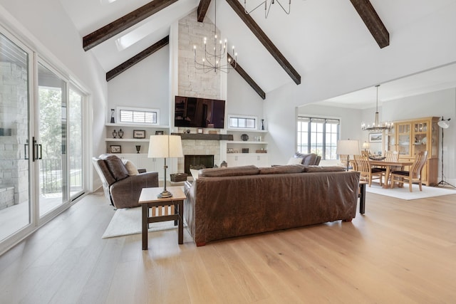 living room featuring a fireplace, high vaulted ceiling, beamed ceiling, a chandelier, and light wood-type flooring