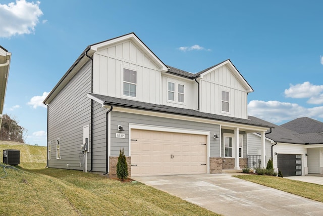 view of front of property with central AC unit, concrete driveway, covered porch, board and batten siding, and a front yard