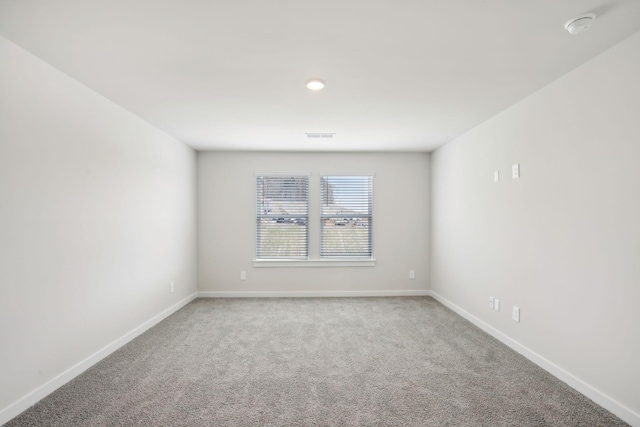 spare room with carpet floors and baseboards