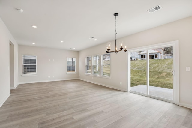 unfurnished dining area featuring a notable chandelier, recessed lighting, visible vents, light wood-style flooring, and baseboards