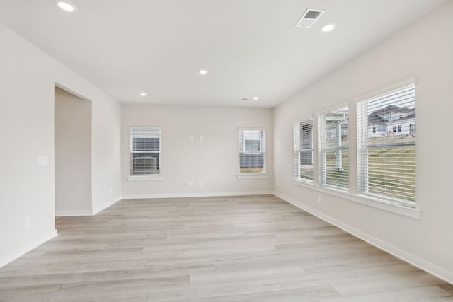 spare room featuring recessed lighting, baseboards, visible vents, and light wood finished floors