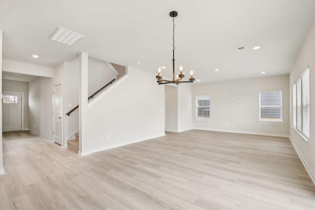 unfurnished living room featuring light wood-style floors, stairs, baseboards, and recessed lighting