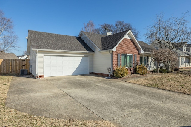 view of front facade featuring a garage and central AC unit