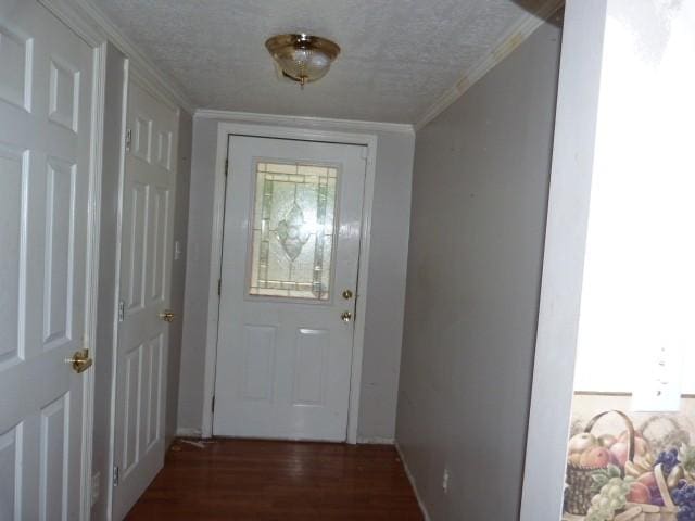 doorway to outside with crown molding, dark hardwood / wood-style flooring, and a textured ceiling