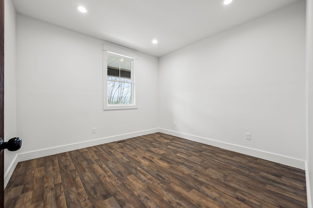 spare room with dark hardwood / wood-style flooring