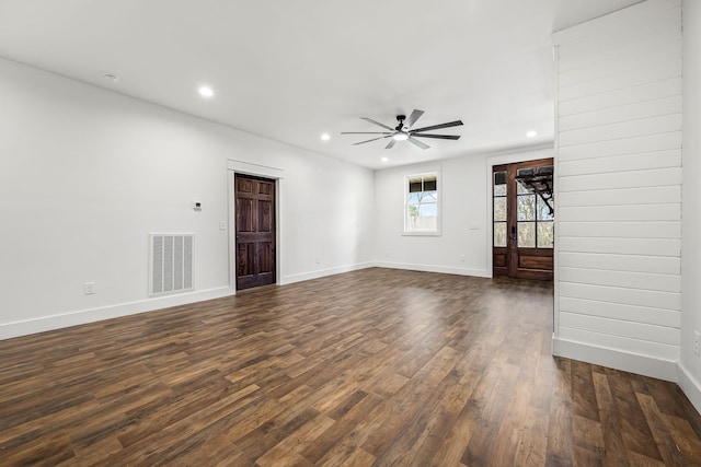 empty room featuring dark wood-type flooring and ceiling fan