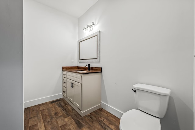 bathroom with vanity, wood-type flooring, and toilet