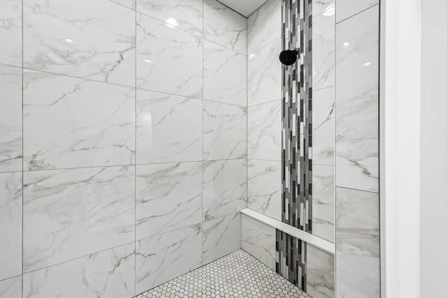 bathroom with a tile shower