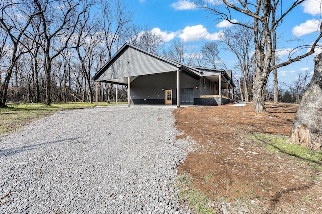 view of home's exterior with a carport and a garage