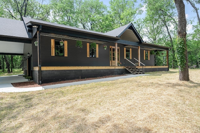 view of front of house featuring roof with shingles and covered porch