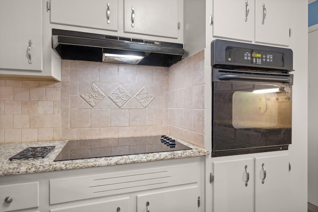 kitchen featuring white cabinetry, light stone countertops, backsplash, and black appliances