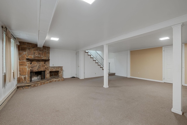 basement with baseboard heating, carpet flooring, and a fireplace