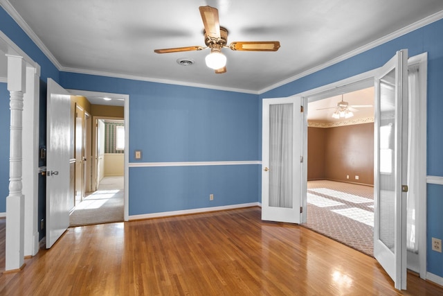 unfurnished bedroom with ornamental molding, wood-type flooring, ceiling fan, and french doors