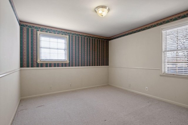 unfurnished room featuring plenty of natural light and light colored carpet