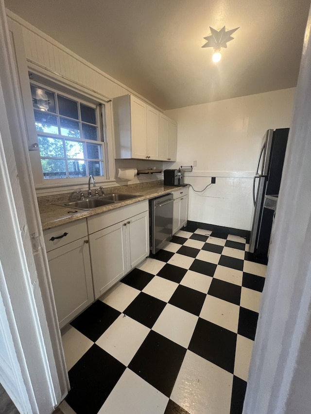 kitchen with white cabinetry, sink, and stainless steel appliances