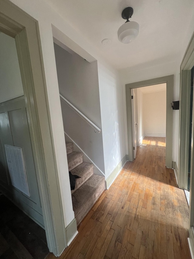 corridor with wood-type flooring