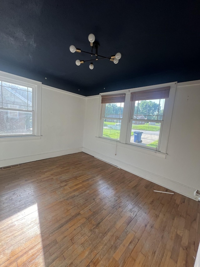 spare room featuring hardwood / wood-style floors