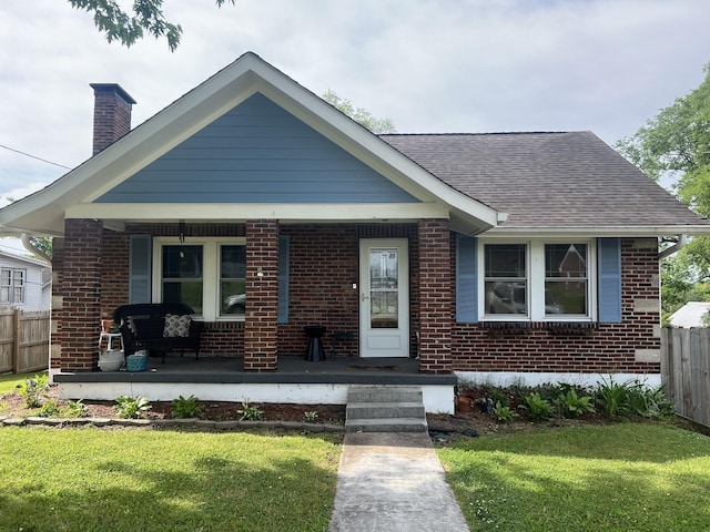 bungalow-style home featuring a porch and a front yard