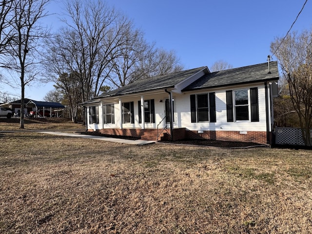 ranch-style home with a carport, a porch, and a front lawn