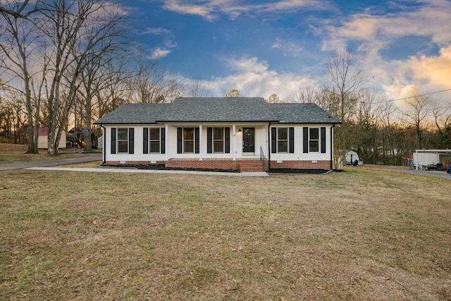 single story home with a lawn