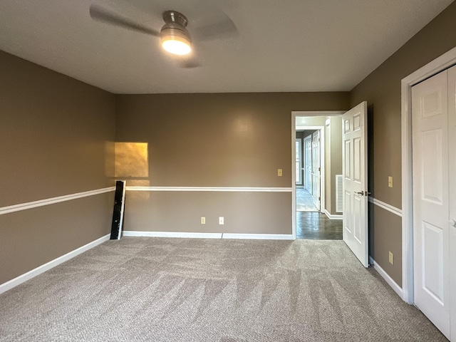 unfurnished room with carpet and ceiling fan