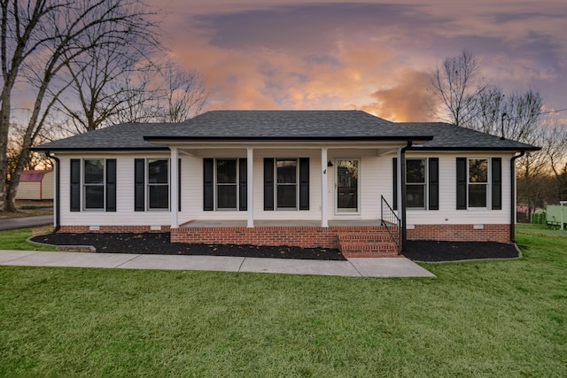 single story home featuring a porch and a yard