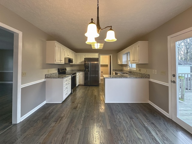 kitchen featuring dark stone countertops, hanging light fixtures, stainless steel appliances, and white cabinets