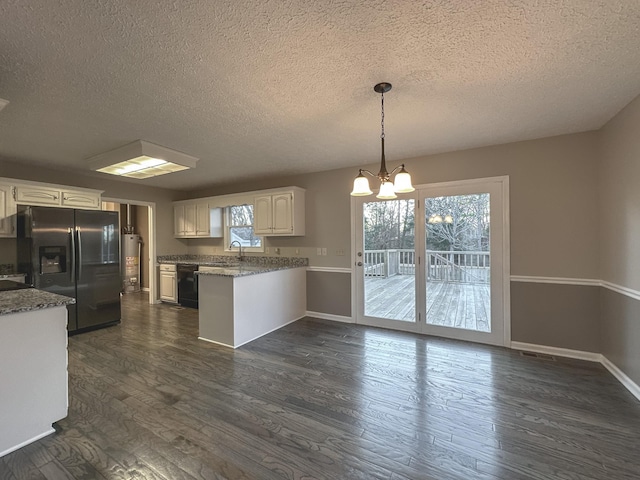 kitchen featuring stainless steel fridge, black dishwasher, white cabinets, and decorative light fixtures