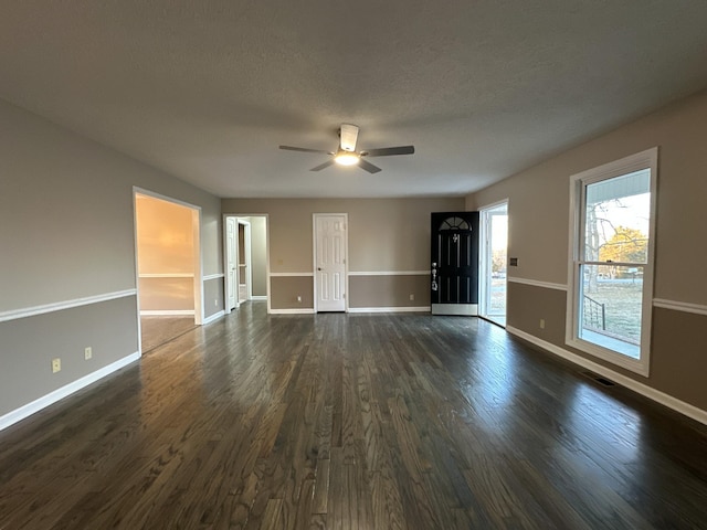 interior space featuring dark wood-type flooring, a textured ceiling, and ceiling fan