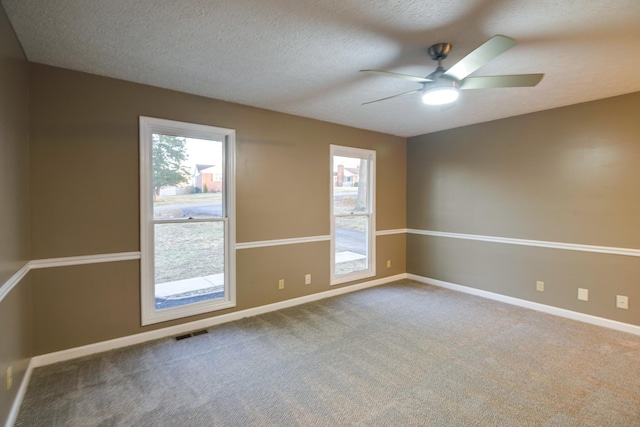 unfurnished room featuring carpet flooring, a textured ceiling, and ceiling fan