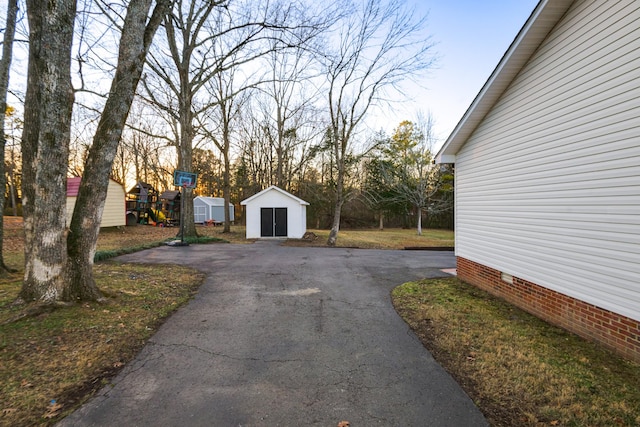 view of yard with a playground and a shed