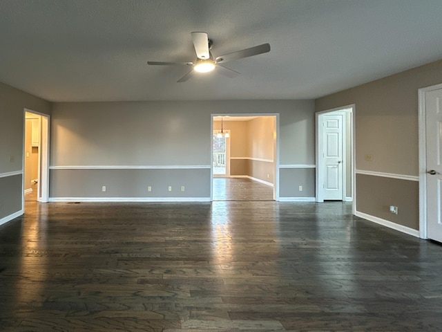 unfurnished room with ceiling fan and dark hardwood / wood-style flooring