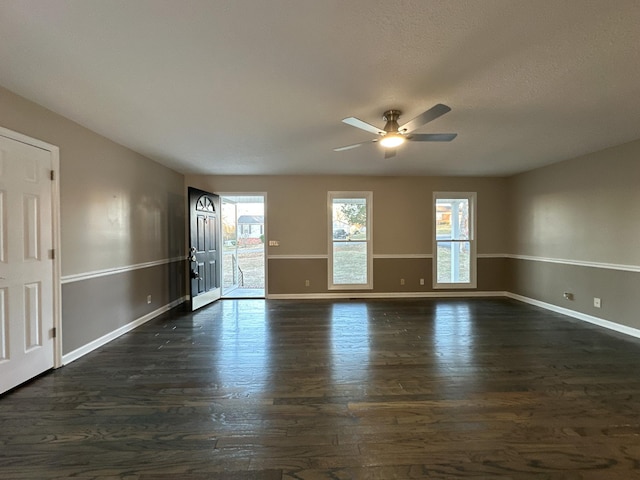 unfurnished room with ceiling fan and dark hardwood / wood-style flooring