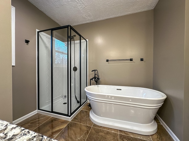 bathroom featuring shower with separate bathtub and a textured ceiling