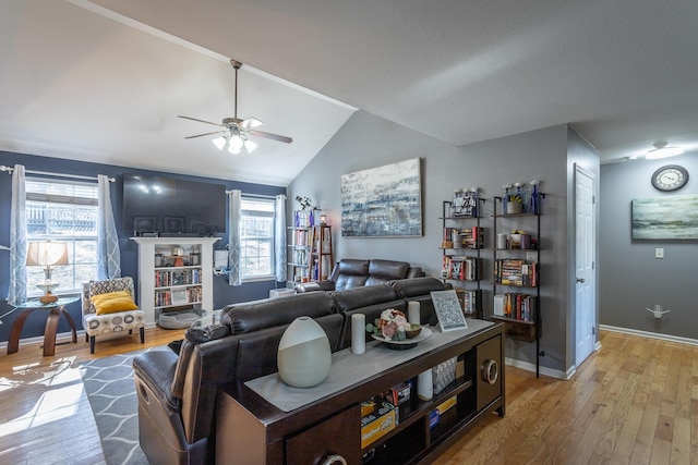 living room with ceiling fan, lofted ceiling, and light hardwood / wood-style floors