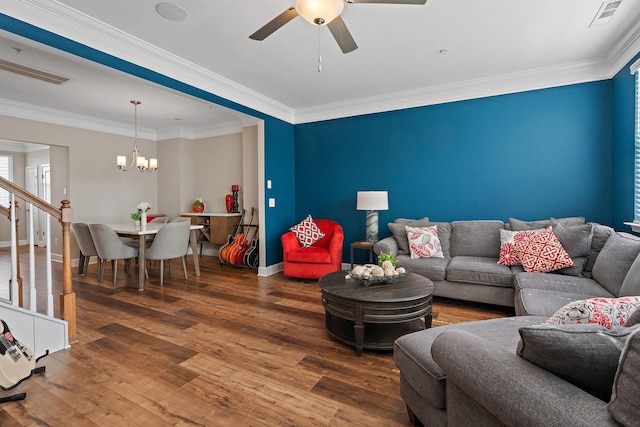 living room featuring crown molding, wood-type flooring, and ceiling fan with notable chandelier