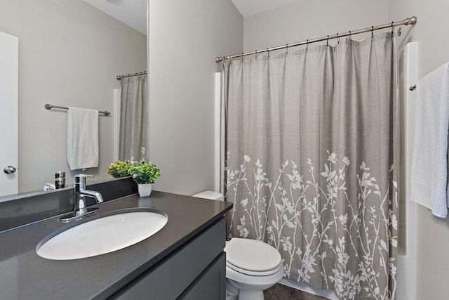 bathroom featuring vanity, toilet, and a shower with shower curtain