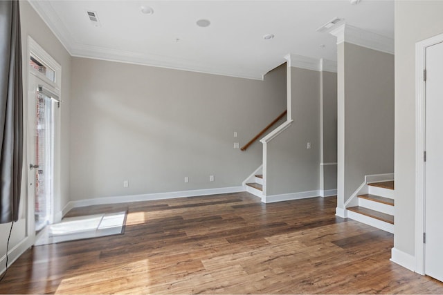 entryway with ornamental molding and dark hardwood / wood-style floors