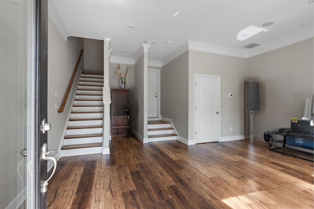 foyer entrance with dark wood-type flooring and ornamental molding