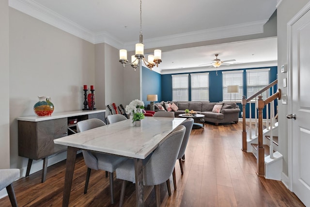 dining space featuring crown molding, ceiling fan with notable chandelier, and dark hardwood / wood-style flooring