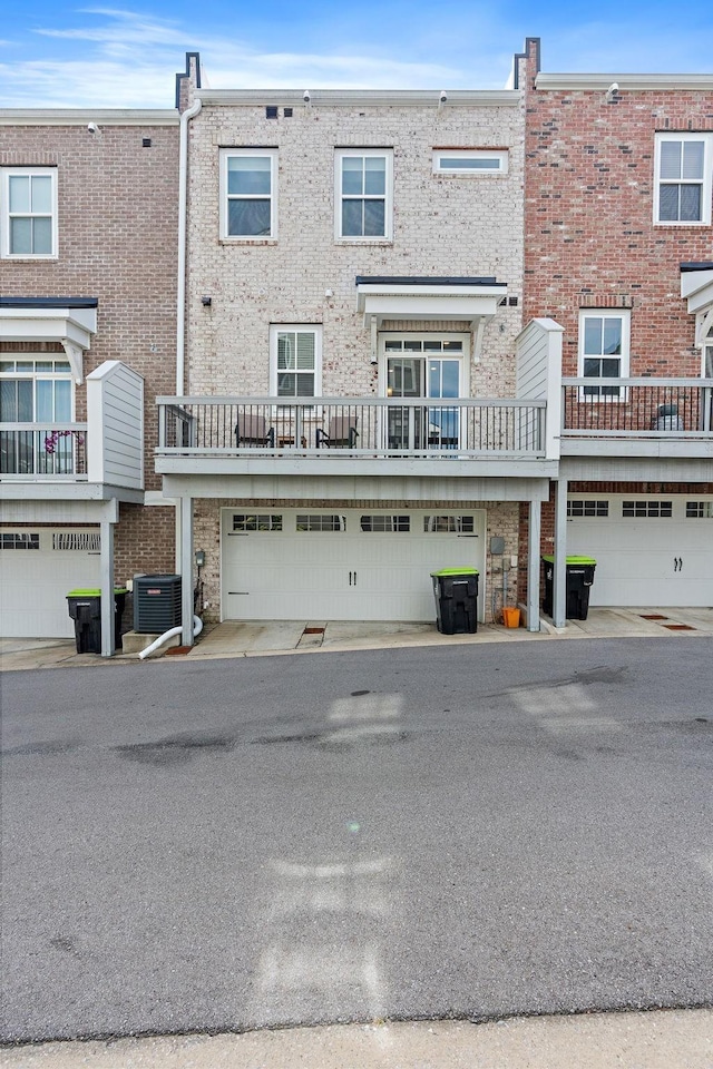 back of property featuring a garage and central AC unit