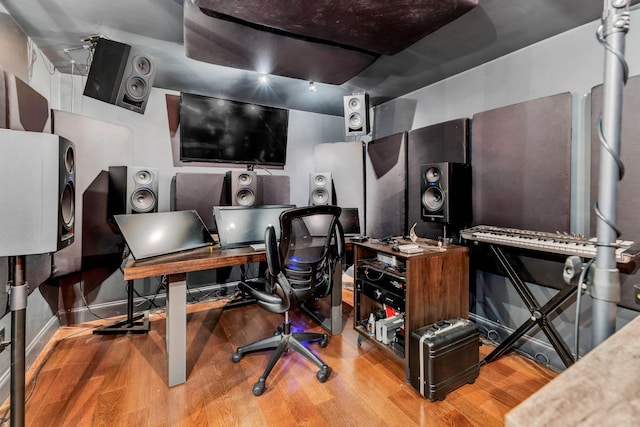 home office with light hardwood / wood-style flooring