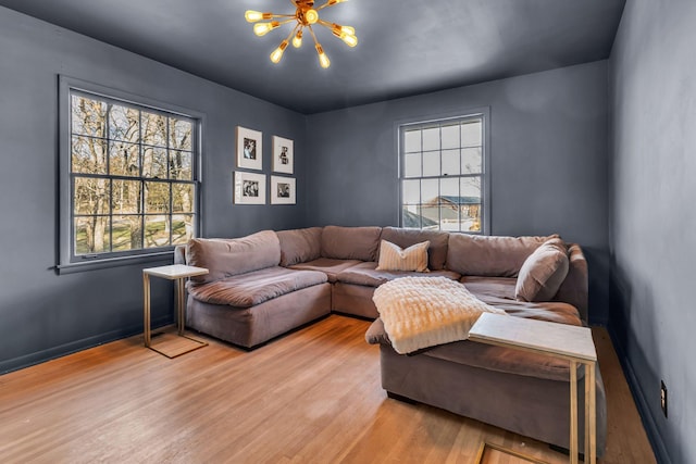 living room featuring light hardwood / wood-style floors and a notable chandelier