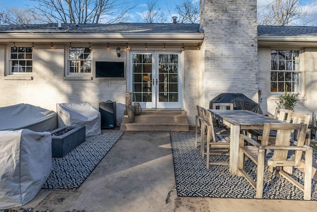 view of patio / terrace with french doors and an outdoor fire pit