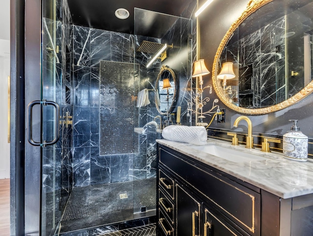 bathroom with vanity and a shower with door