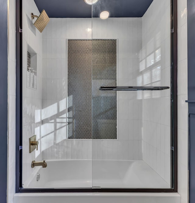 bathroom featuring shower / bath combination with glass door